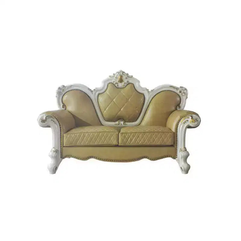 Causeuse capitonnée avec cadre sculpté et coussins décoratifs