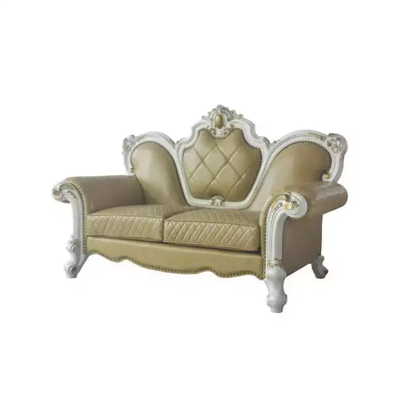 Causeuse capitonnée avec cadre sculpté et coussins décoratifs